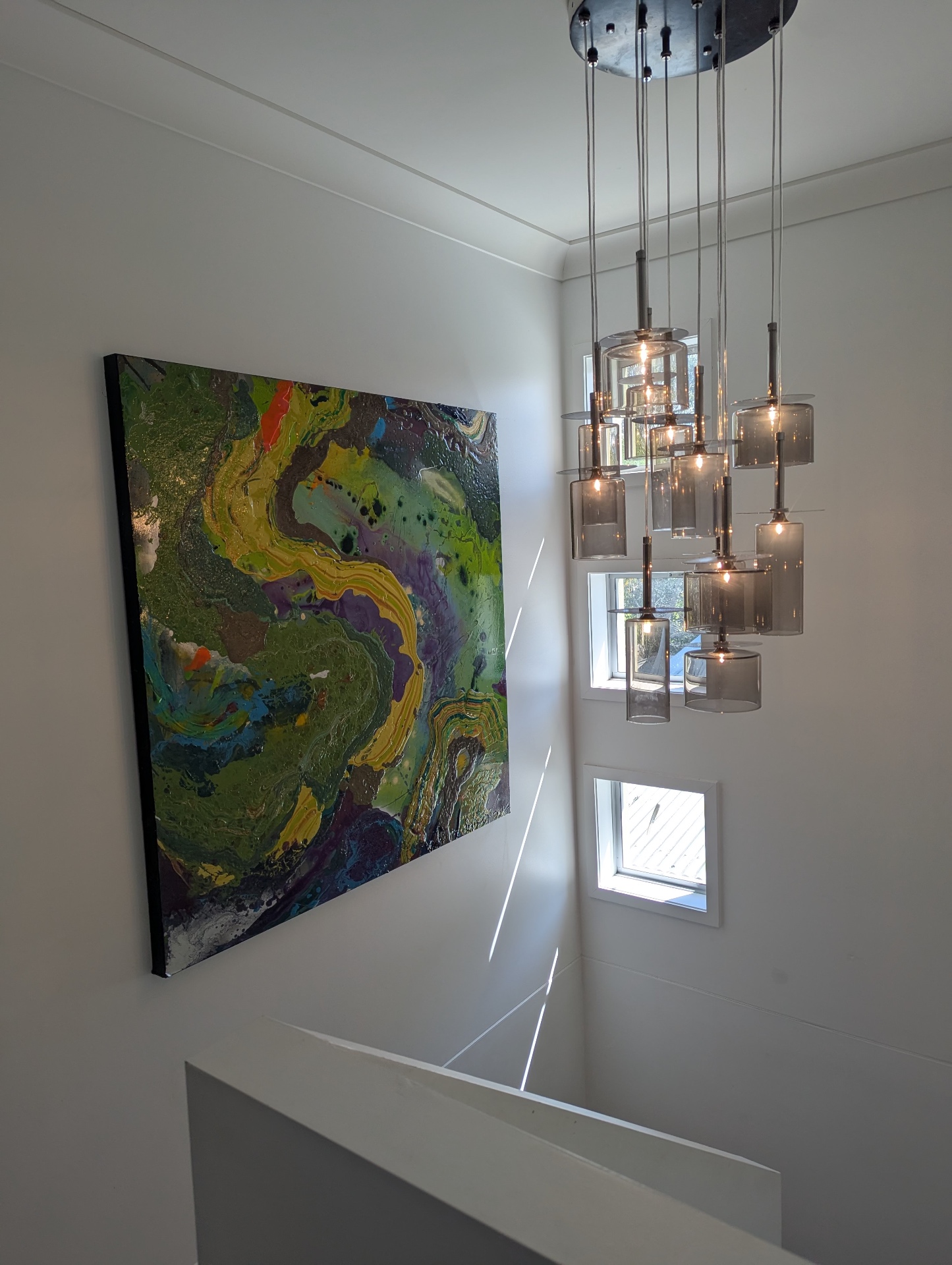 Custom pendant chandelier installation in stairwell
